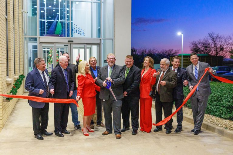 Ribbon cutting ceremony celebrating the opening of the new City Hall in The Colony, Texas with city leaders and The Colony Chamber of Commerce.